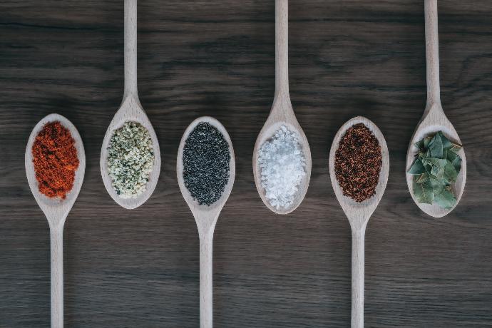 assorted-color spoons with spices